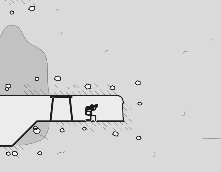 A miner crouched at the rock face, deep underground.